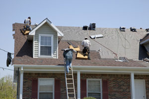 Men working on roof of house